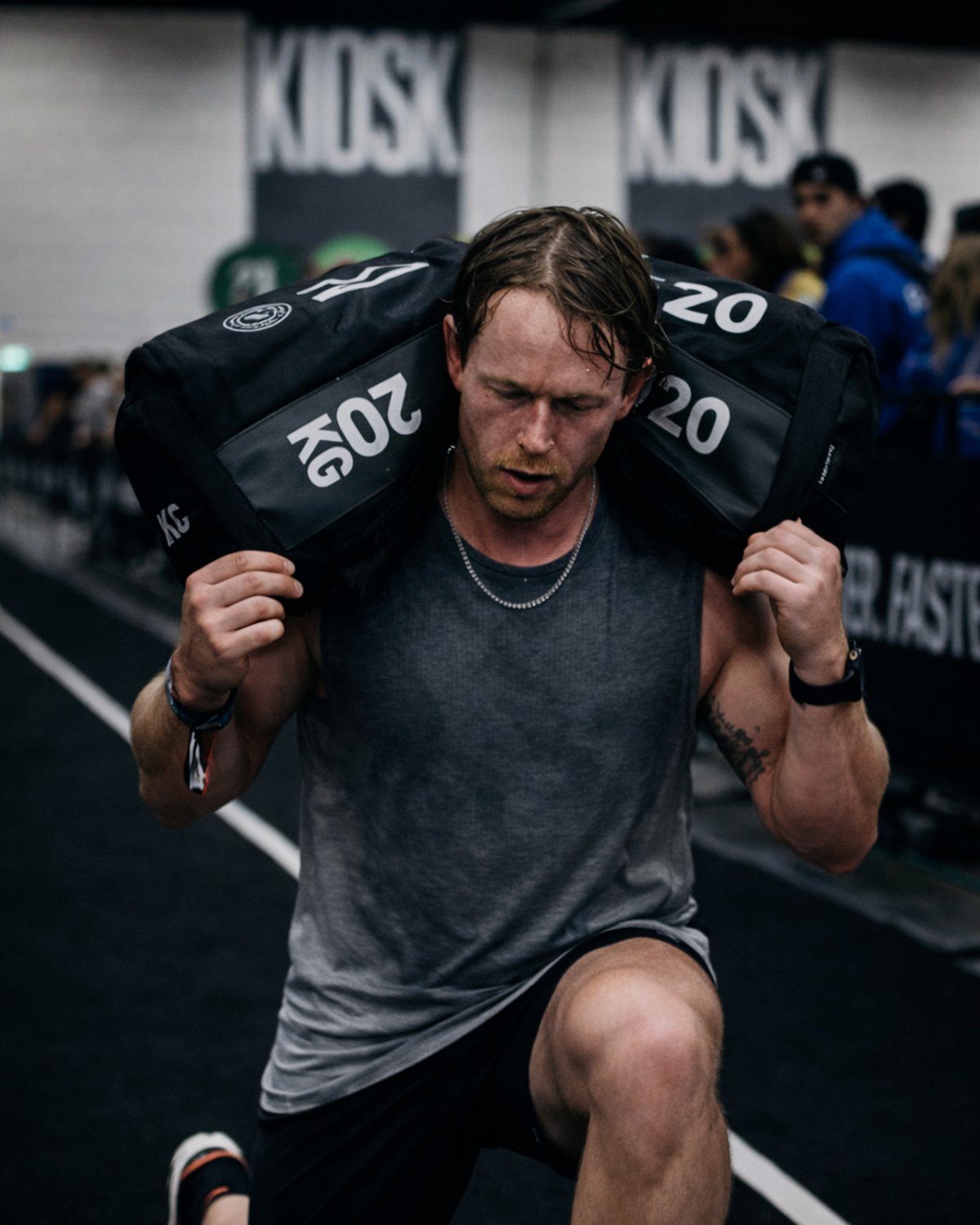 Eaden Project athlete doing HYROX sandbag lunges